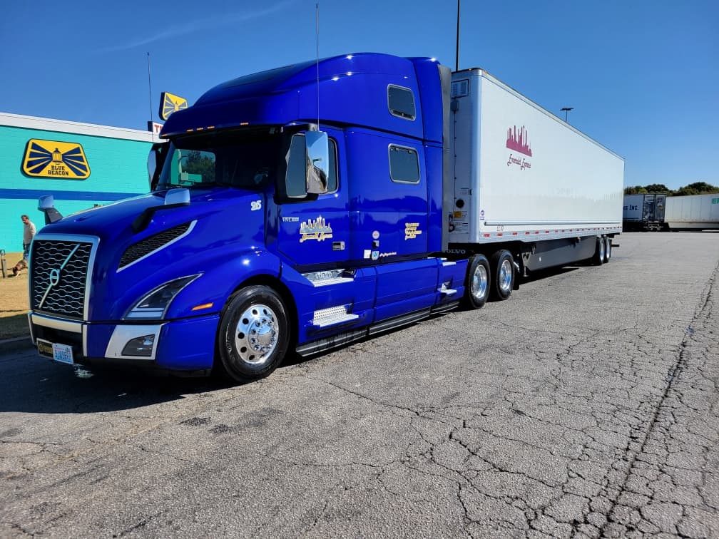 Emerald Express blue Volvo VNL with branded 53-foot trailer