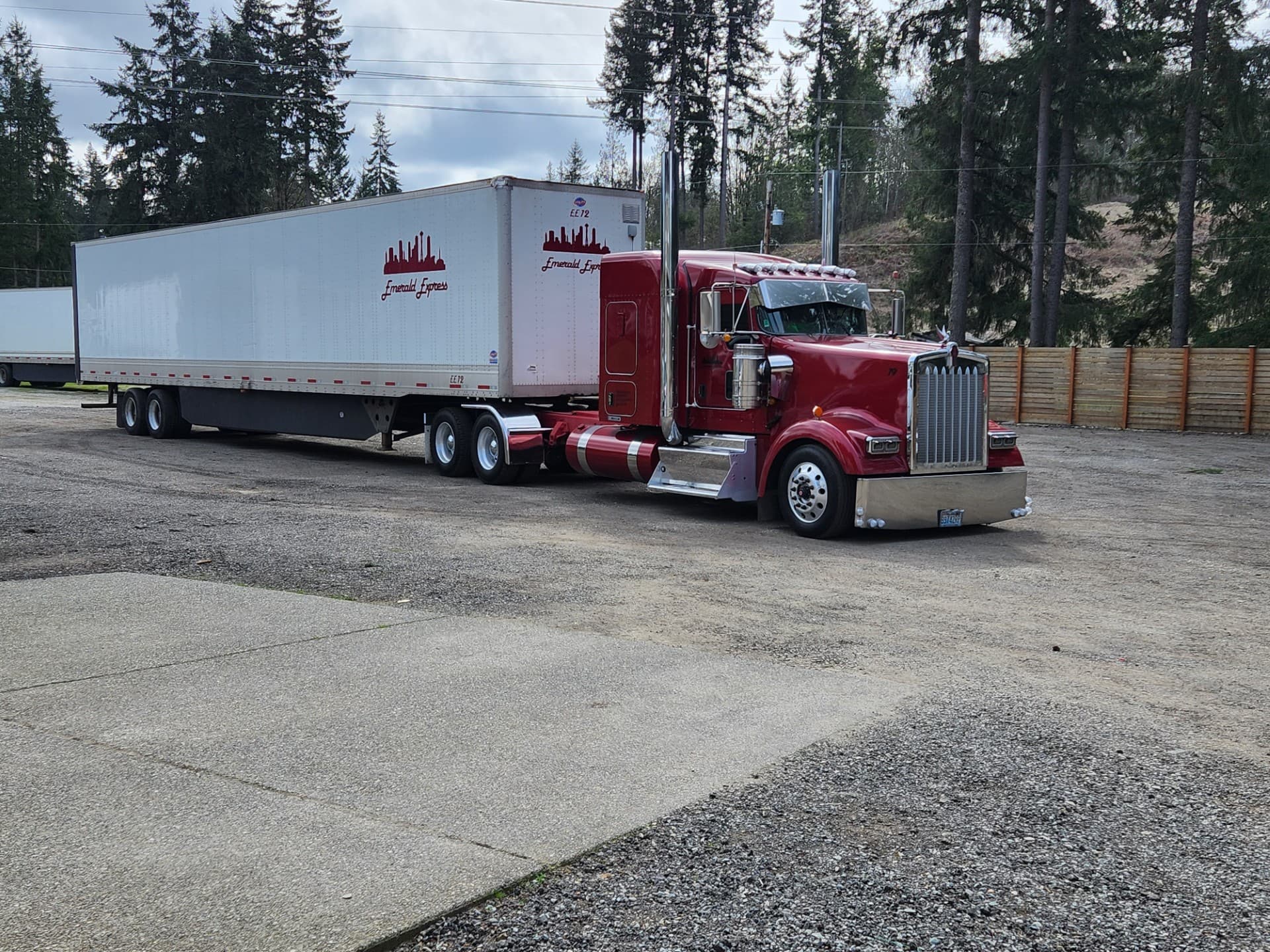 Emerald Express Kenworth W900 with branded 53-foot trailer at the yard