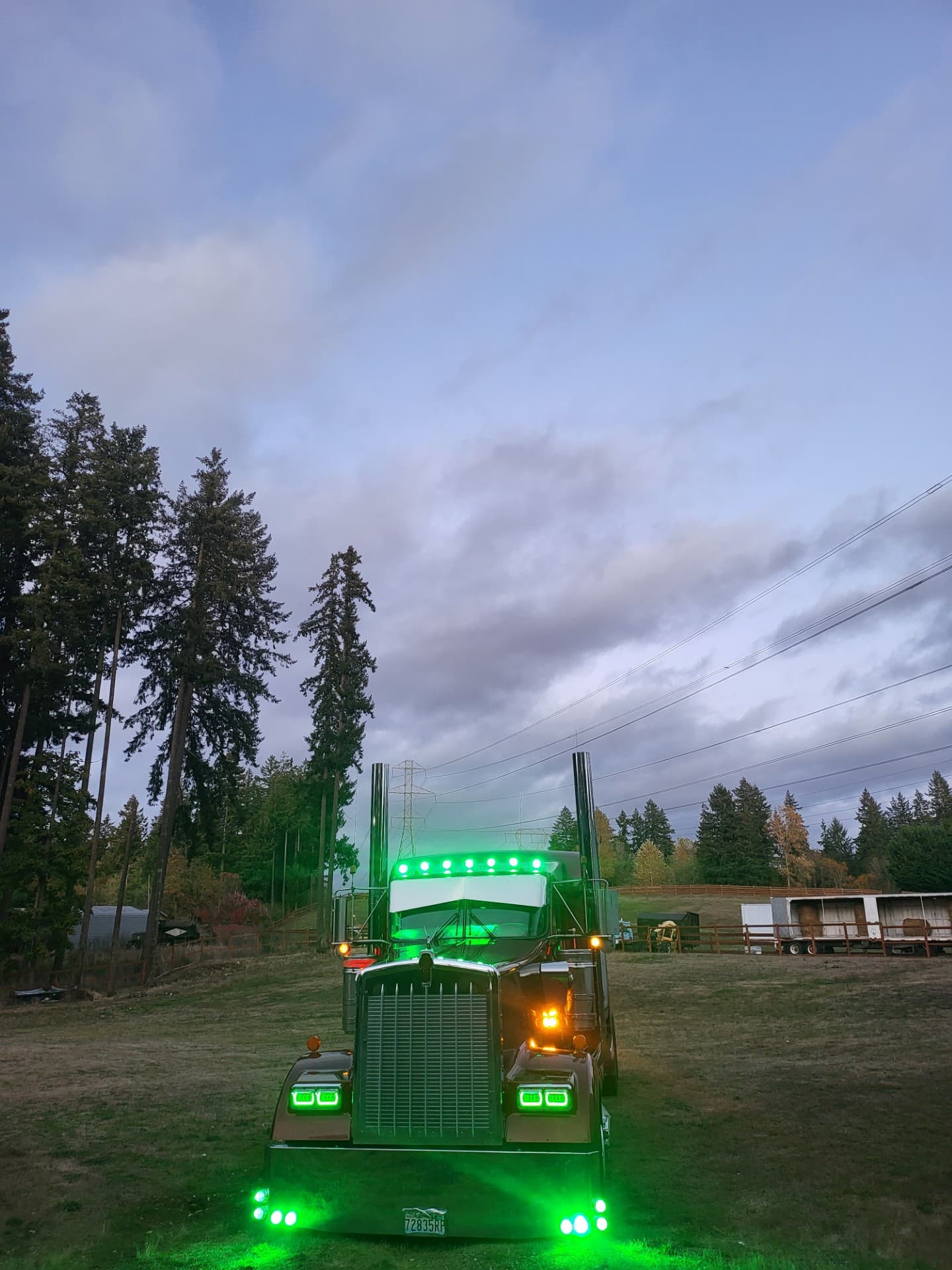 Emerald Express Kenworth W900 glowing green at dusk