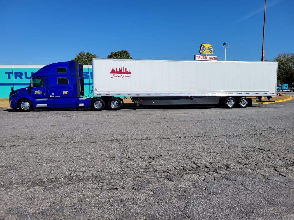 Emerald Express Volvo VNL with branded 53-foot dry van trailer